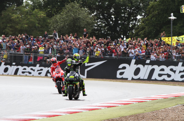 British Grand Prix. 
Silverstone, England. 30th August - 1st September 2013. 
Cal Crutchlow, Tech 3 Yamaha, Valentino Rossi, Yamaha, and Nicky Hayden, Ducati, wave to the crowd. 
Ref: IMG_2423a. World copyright: Kevin Wood/LAT Photographic