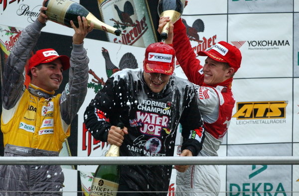 Race winner and 2002 champion Gary Paffett (GBR), Team Rosberg, centre, gets a champagne shower from second placed Timo Glock (GER), left, Opel Team KMS,  and third placed Ryan Briscoe (AUS), right, Prema Powerteam.
German Formula 3 Championship, Rd10, Hockenheim, Germany, 5-6 October 2002.
DIGITAL IMAGE