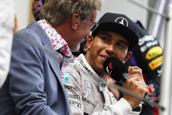 Circuit de Catalunya, Barcelona, Spain.
Sunday 11 May 2014.
Eddie Jordan, TV Pundit, BBC Sport F1, interviews Lewis Hamilton, Mercedes AMG, 1st Position, on the podium.
World Copyright: Steven Tee/LAT Photographic.
ref: Digital Image _L4R4382