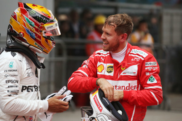 Shanghai International Circuit, Shanghai, China.  Sunday 09 April 2017. 
Sebastian Vettel, Ferrari, 2nd Position, congratulates Lewis Hamilton, Mercedes AMG, 1st Position, in Parc Ferme.
World Copyright: Charles Coates/LAT Images 
ref: Digital Image AN7T0855