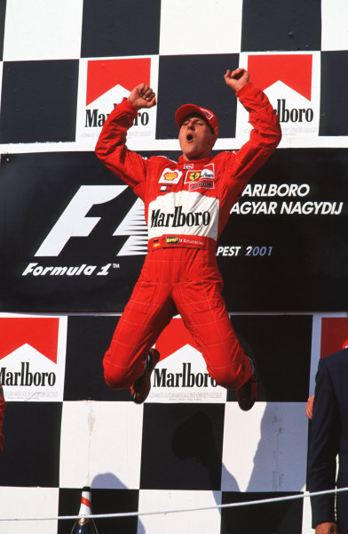 2001 Hungarian Grand Prix.
Hungargoring, Budapest, Hungary.
17-19 August 2001.
Race winner Michael Schumacher, Ferrari F2001 jumps in the air in joy after clinching 4th World driver championship, and Ferrari's 3rd consecutive constructors title. Podium.
World Copyright: Charles Coates/ LAT Photographic
ref: 35mm Image A21







