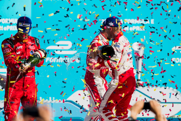 2016/2017 FIA Formula E Championship.
Round 7 - Berlin ePrix, Tempelhof Airport, Berlin, Germany.
Saturday 10 June 2017.
Lucas Di Grassi (BRA), ABT Schaeffler Audi Sport, Spark-Abt Sportsline, ABT Schaeffler FE02, and Felix Rosenqvist (SWE), Mahindra Racing, Spark-Mahindra, Mahindra M3ELECTRO, spray the champagne on the podium.
Photo: Zak Mauger/LAT/Formula E
ref: Digital Image _54I7719