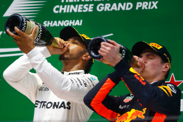 Shanghai International Circuit, Shanghai, China.  Sunday 09 April 2017. 
Lewis Hamilton, Mercedes AMG, 1st Position, and Max Verstappen, Red Bull, 3rd Position, celebrate with Champagne on the podium.
World Copyright: Steven Tee/LAT Images 
ref: Digital Image _O3I5584