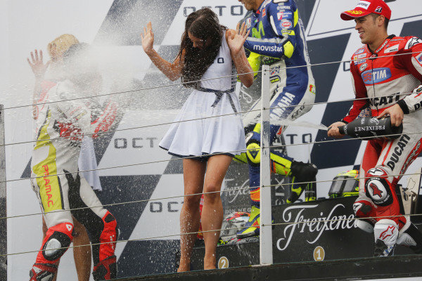 2015 MotoGP Championship. 
British Grand Prix. 
Silverstone, England. 28th - 30th August 2015. 
Danilo Petrucci, Pramac Ducati, 2nd position, Valentino Rossi, Yamaha, 1st position, and Andrea Dovizioso, Ducati, 3rd position, celebrate on the podium. 
Ref: KW5_5596a. World copyright: Kevin Wood/LAT Photographic