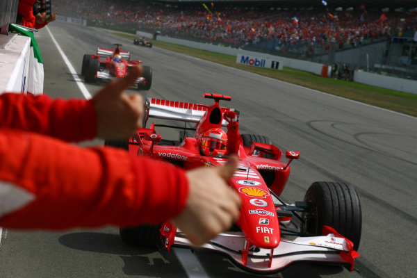 Michael Schumacher and Felipe Massa, Ferrari 248 F1, celebrate a Ferrari 1-2 as they pass their team on the pitwall. Michael Schumacher and Felipe Massa, Ferrari 248 F1, celebrate a Ferrari 1-2 as they pass their team on the pitwall.